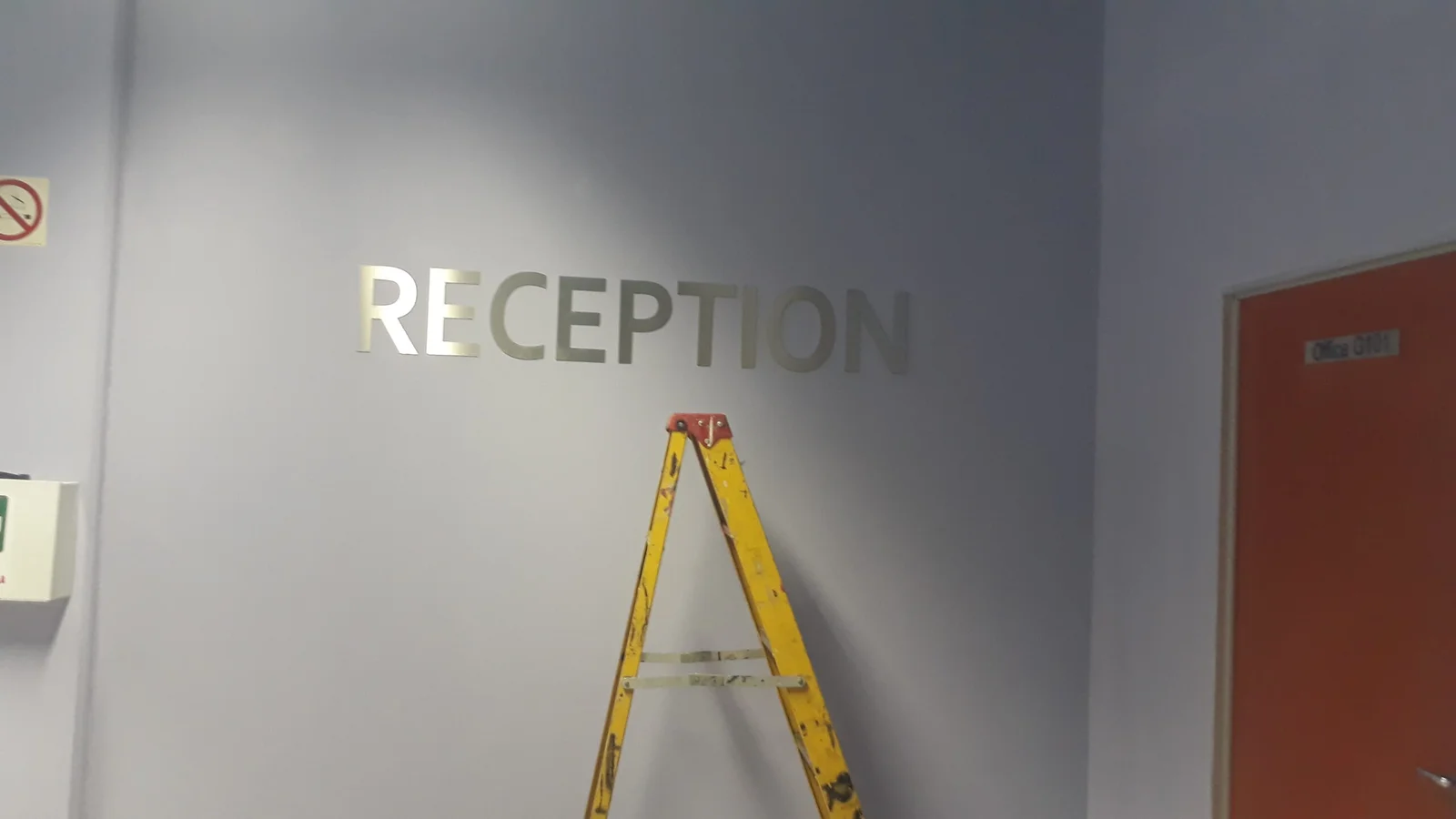 Reception stainless steel wall lettering installation